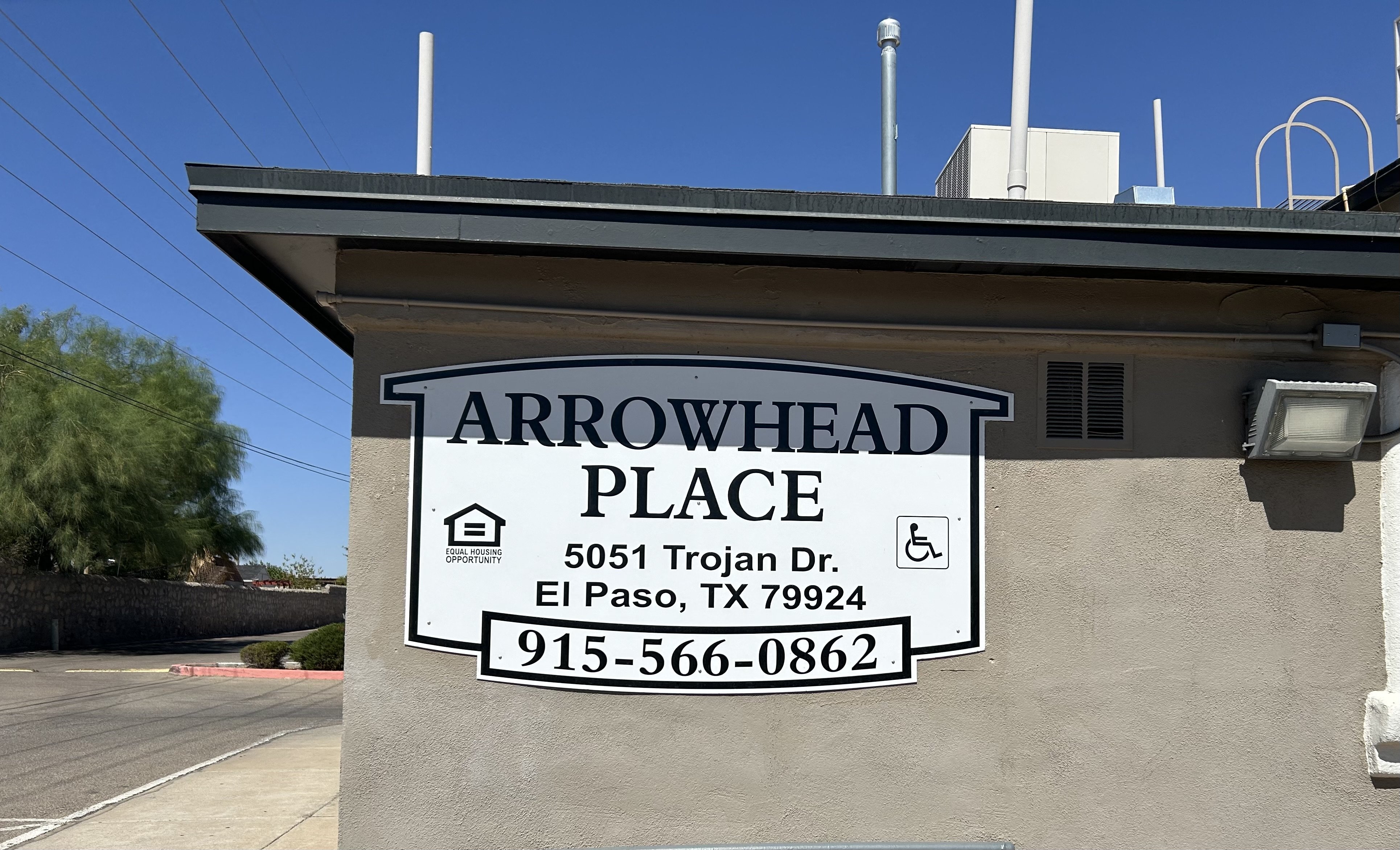 a sign for an arrowhead place on the side of a building